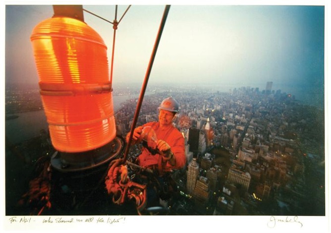 Man Changing Lightbulb on Empire State Building by Joe McNally on artnet